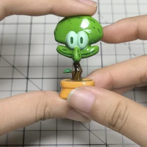 A unique handcrafted resin Squidward potted plant artisan keycap, whimsically designed for mechanical keyboards, bringing pop-culture charm to your desk.