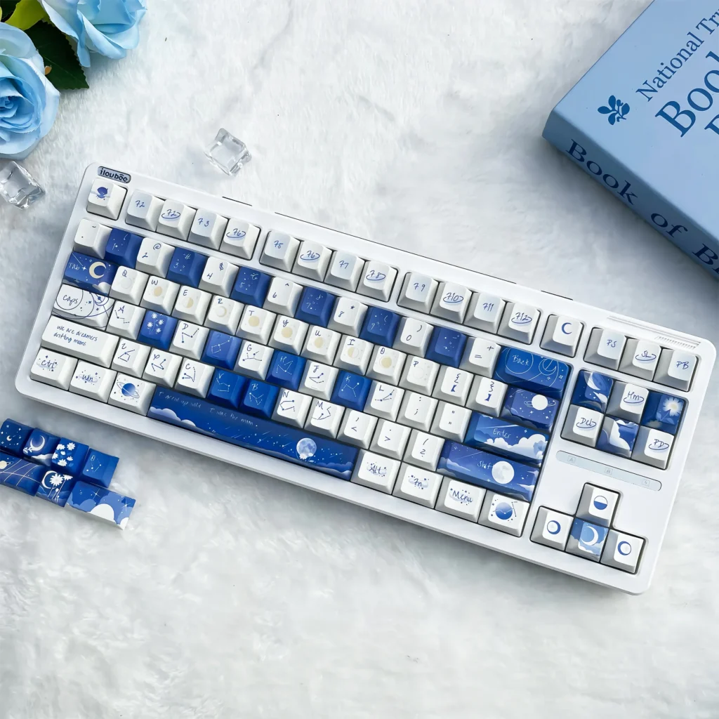 Main display of the Starry PBT keycap set for mechanical keyboards, featuring a vibrant deep blue cosmic design with twinkling stars.
