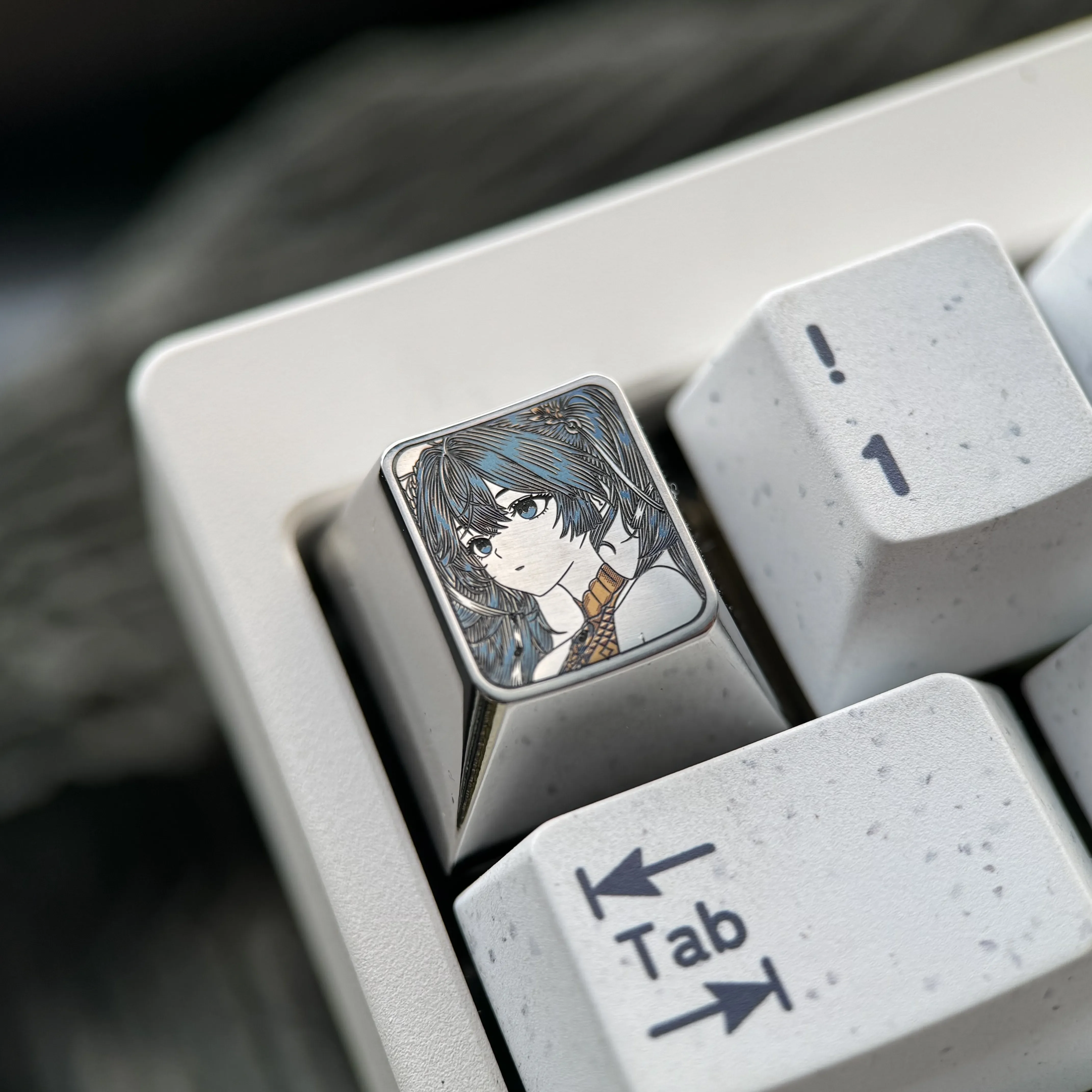 Close-up gallery of the artisan Wuthering Waves: Iuno Keycap, highlighting intricate precision-engraved detail and lustrous polished titanium.