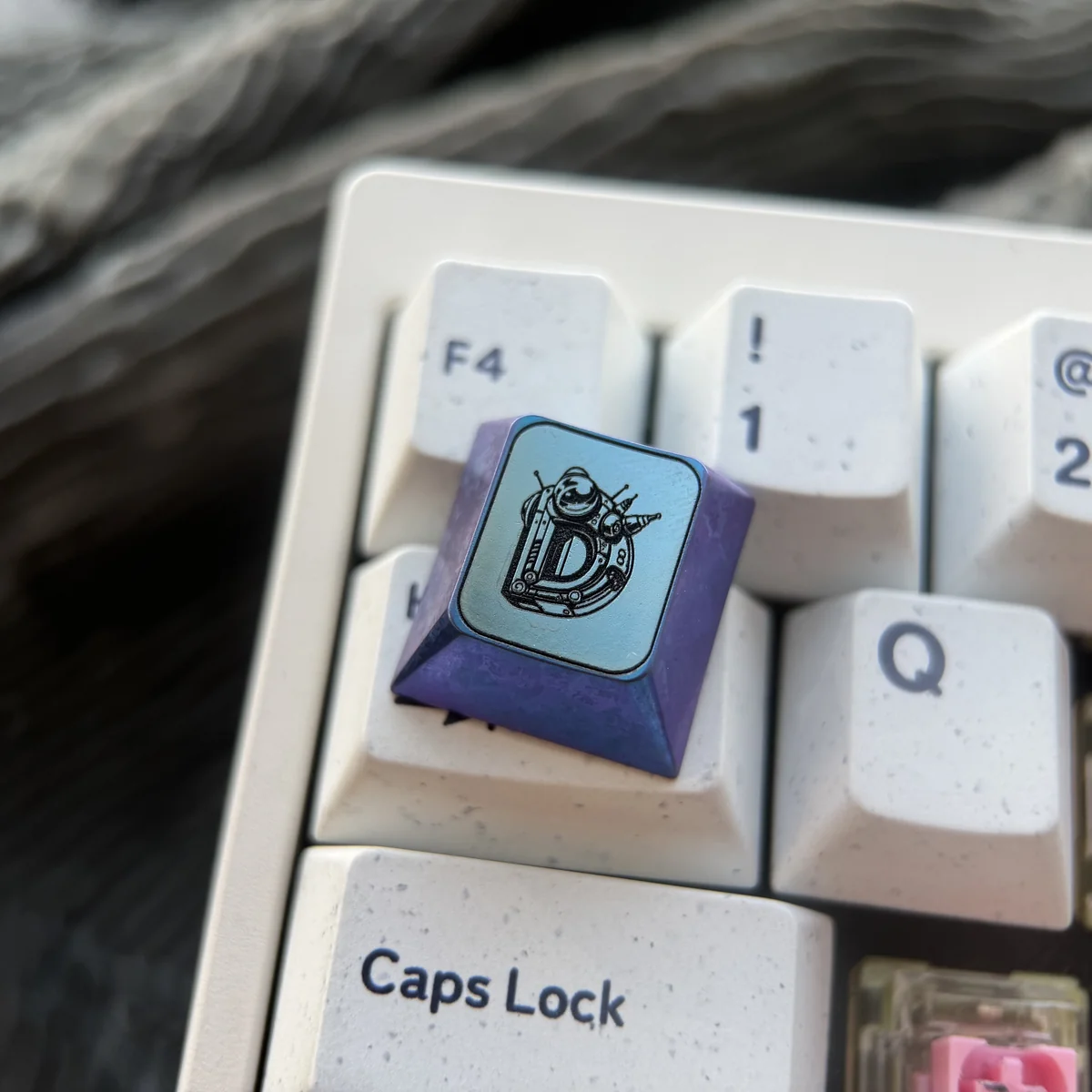 Titanium Gundam WASD gaming keycaps from a dynamic angle, highlighting their intricate industrial design and vibrant anodized finish.