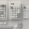 Tyche-One minimalist PBT keycaps product gallery, showcasing crisp dye-sub legends, durable PBT material, and sleek design from multiple perspective view.