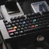 Detailed view of Ag1921 Braun-inspired PBT Wooting keycaps set, highlighting their sleek dark aesthetic, precise legends, and premium minimalist design.