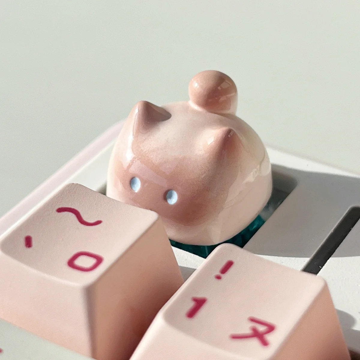 Handcrafted artisan cat keycap, multiple views. Highlights unique, adorable, expressive cat designs in varied colors, enhancing desk aesthetics.