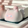 This whimsical handcrafted artisan keycap features an adorable pink blushing cat, a unique and expressive design for your keyboard.