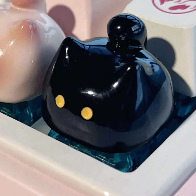 Whimsical handcrafted artisan black cat keycap, an adorable and unique desk accessory with an expressive, premium feline design.