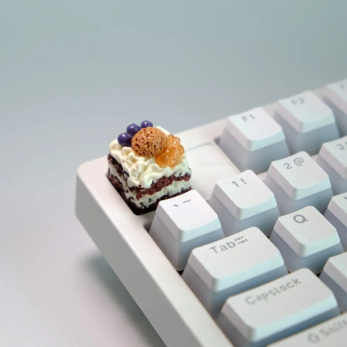Close-up gallery views of vibrant handcrafted artisan dessert keycaps, featuring realistic miniature ice cream and cake sculptures from playful angles