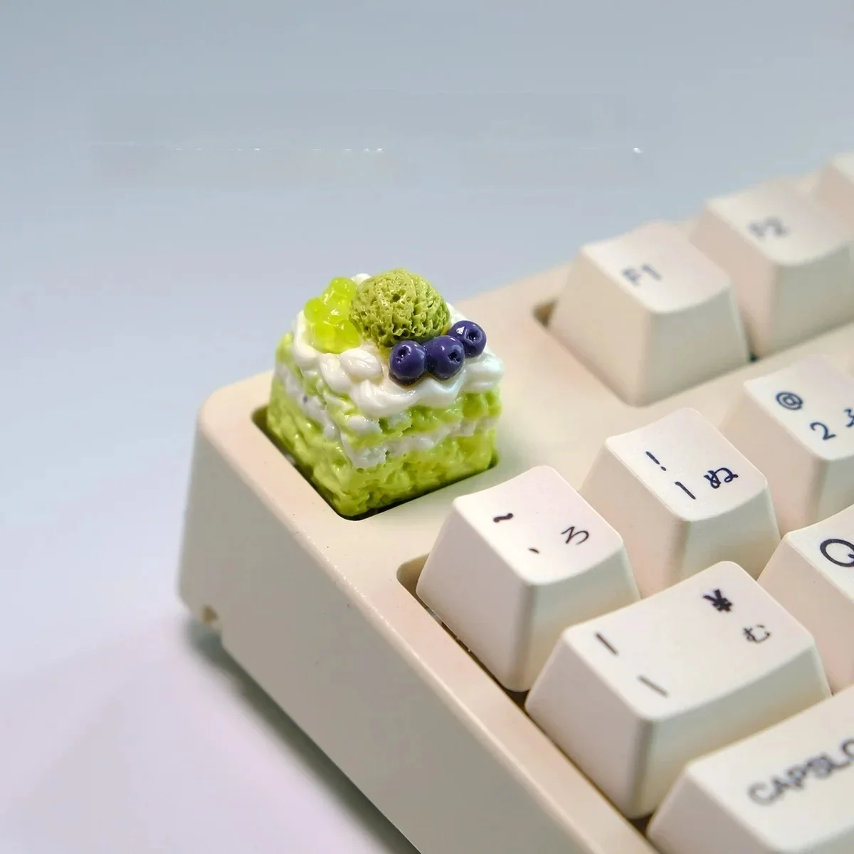 Close-up views of vibrant handcrafted artisan dessert keycaps, showcasing realistic miniature ice cream and cake designs from multiple angles.