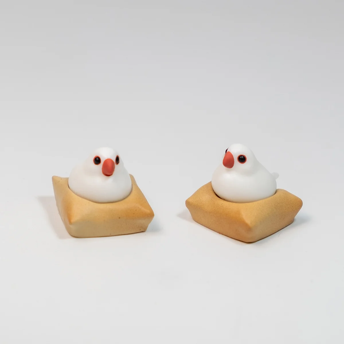 A detailed view of the exquisite handcrafted 3D artisan Java Sparrow keycap from a different angle, showcasing its intricate miniature scene and textured mat.