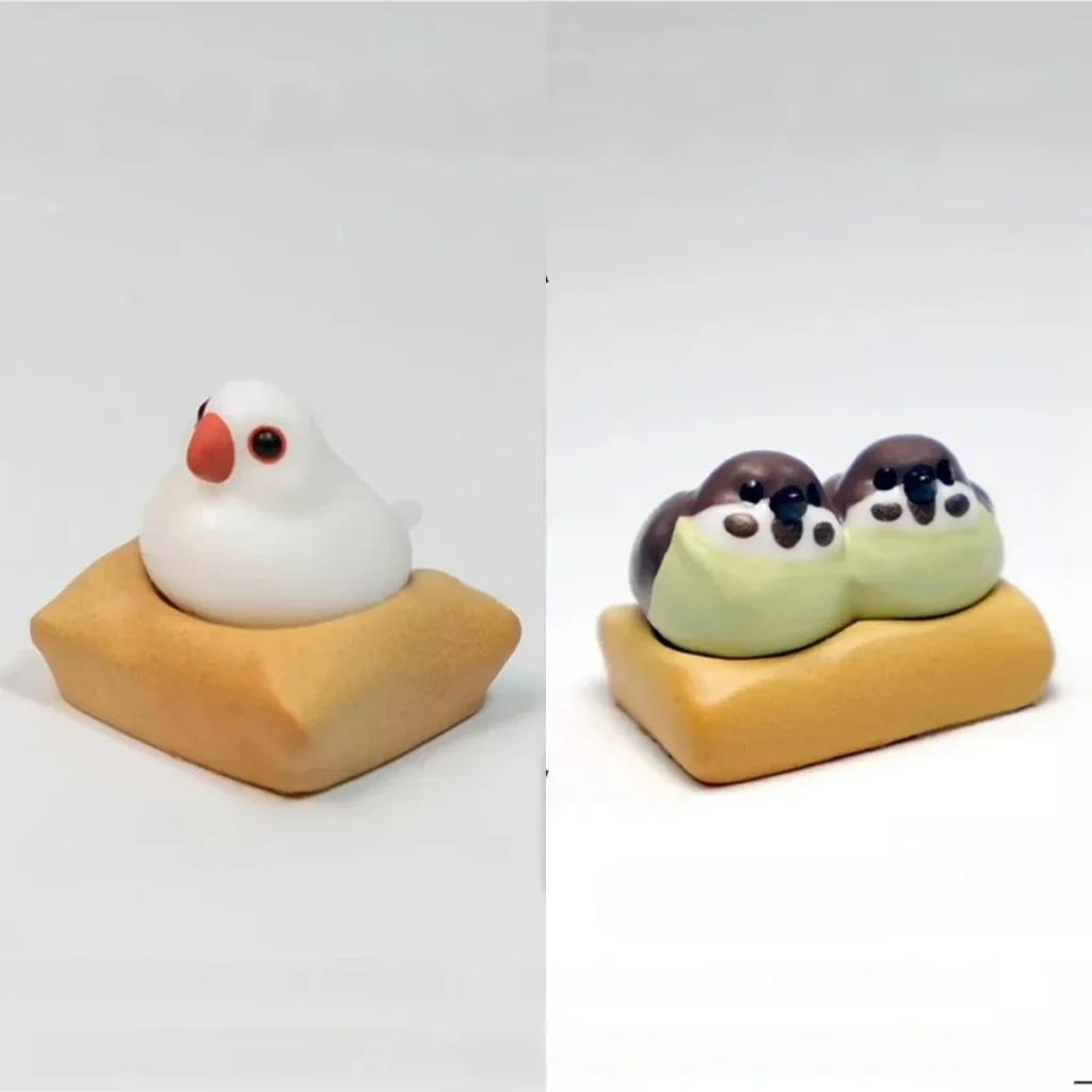 Exquisite handcrafted 3D artisan Java Sparrow keycap showcasing intricate miniature scenes of charming birds on a textured mat.