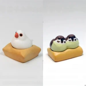 Exquisite handcrafted 3D artisan Java Sparrow keycap showcasing intricate miniature scenes of charming birds on a textured mat.