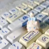 Gallery of the whimsical Fluffy Cat Artisan Keycap, showcasing its unique design, intricate details, and warm white tones from multiple angles.