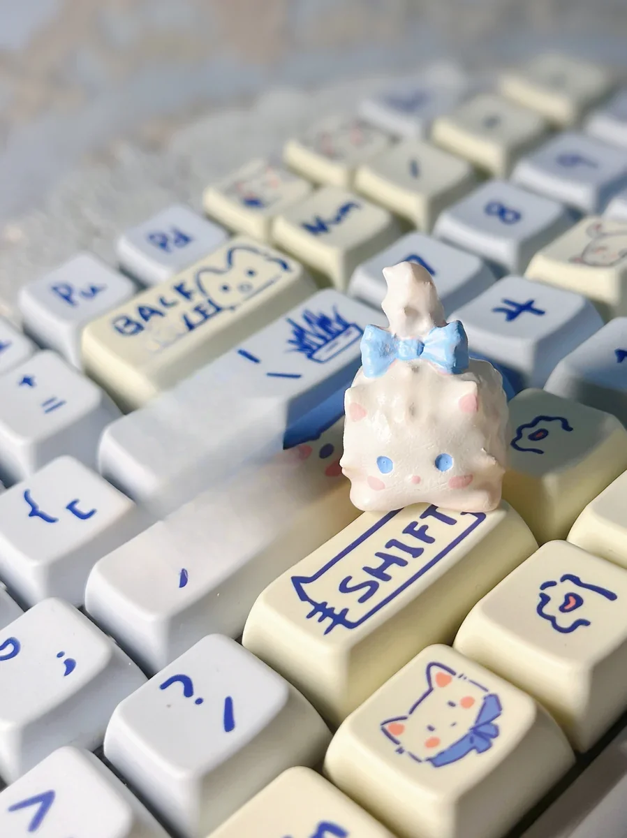 Gallery of the whimsical Fluffy Cat Artisan Keycap, showcasing its unique design, intricate details, and warm white tones from multiple angles.