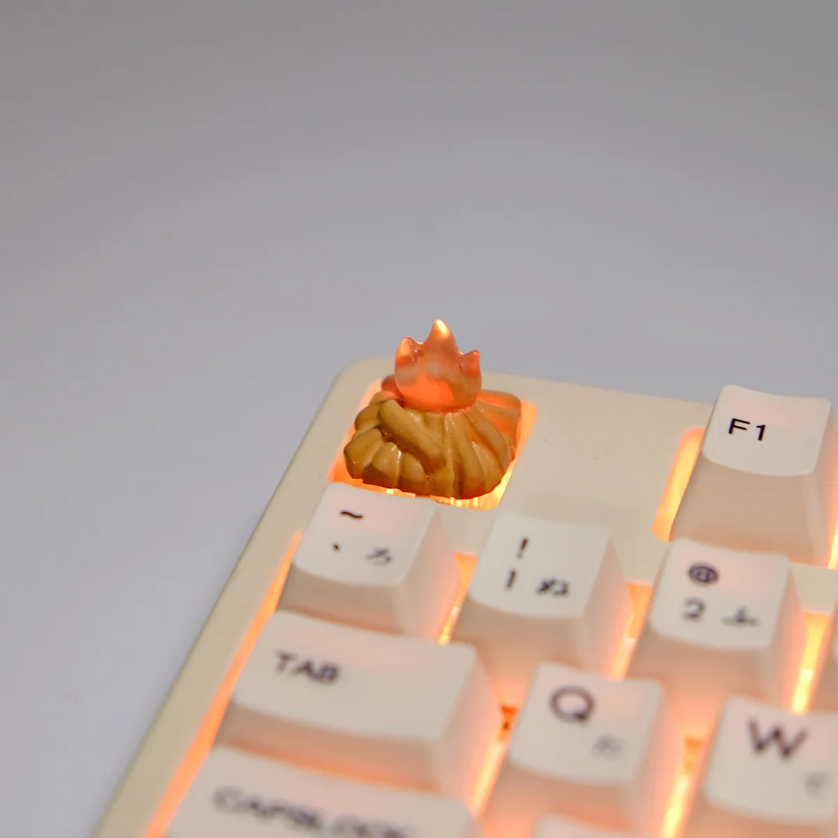 Intricate handmade Glowing Bonfire 3D Artisan Keycap crafted from translucent resin, showcasing its unique design and warm glowing effect from multiple angles.