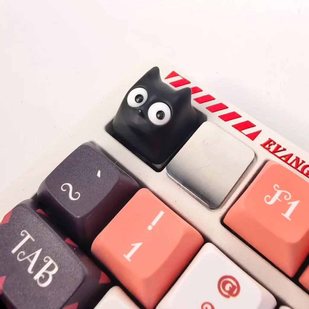A gallery view of the unique Little Black Cat artisan resin ESC keycap, revealing its whimsical design, translucent finish, and intricate handmade details.