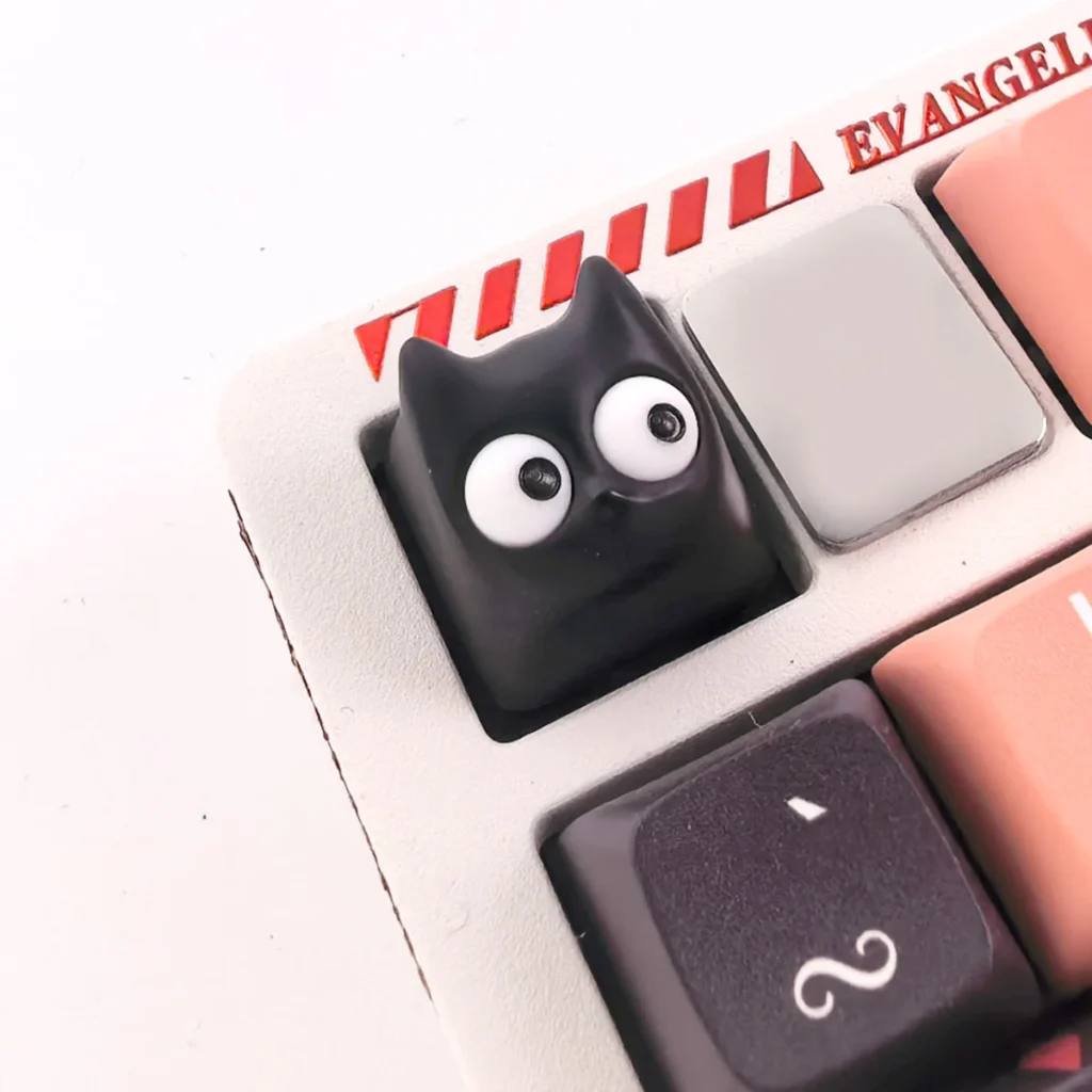 Close-up of a whimsical Little Black Cat artisan resin ESC keycap, showcasing its unique handmade charm and intricate translucent details.