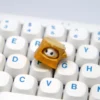 Artistic close-ups of the handmade magnetic hamster stump artisan keycap, highlighting the detachable hamster's cozy charm from multiple angles.