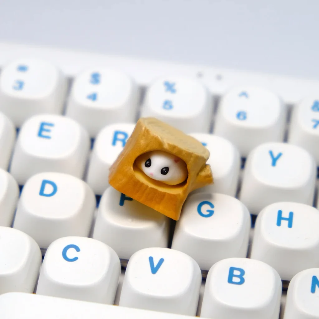 Artistic close-ups of the handmade magnetic hamster stump artisan keycap, highlighting the detachable hamster's cozy charm from multiple angles.