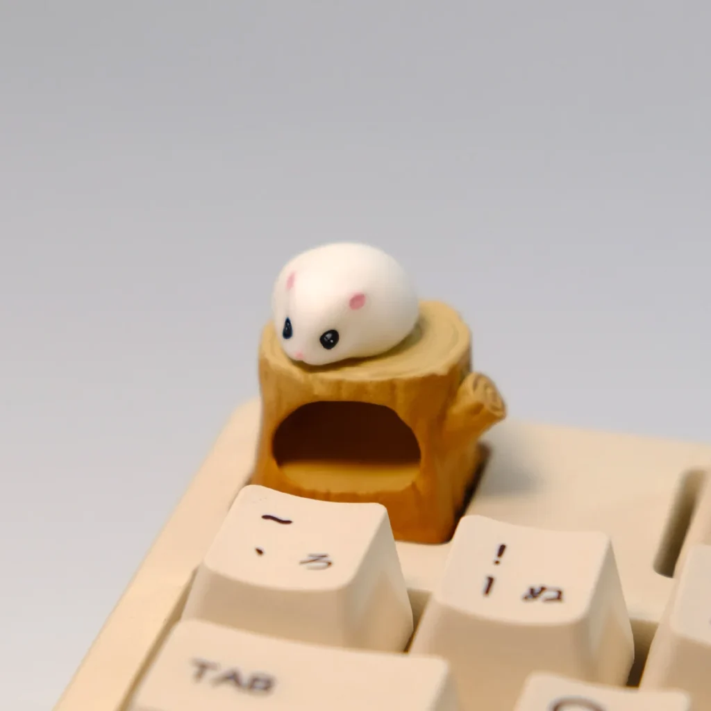 Handmade magnetic hamster artisan keycap, featuring the adorable, detachable hamster sitting cozily on its detailed woodland stump.