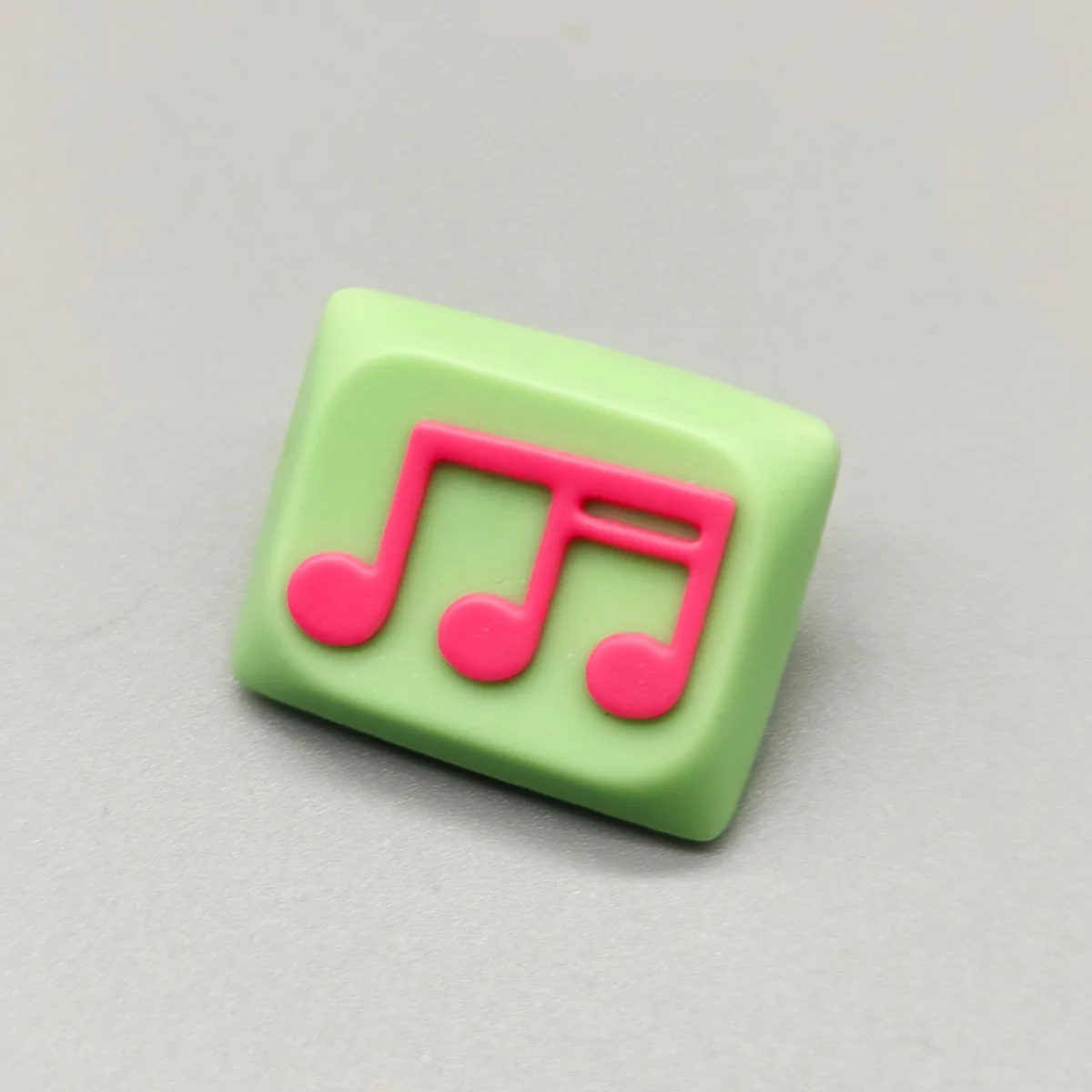 Vibrant green-pink Musical Note Low Shaft Keycaps showcasing a handcrafted, fluid music note design, embodying artistic and playful aesthetics.