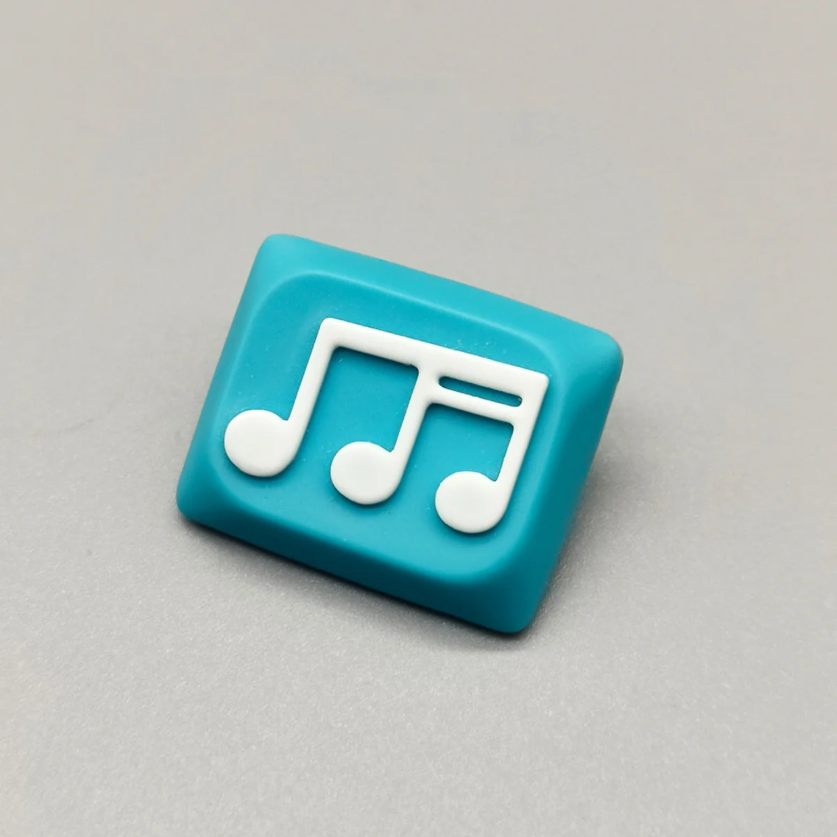 Vibrant blue and white Musical Note Low Shaft Keycaps, showcasing a fluid music note design. Elevate your keyboard's artistic style.