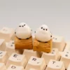 Handcrafted whimsical Bushtit artisan keycap showcasing its adorable 3D sculpted form from a charming front-side perspective on a rustic log.