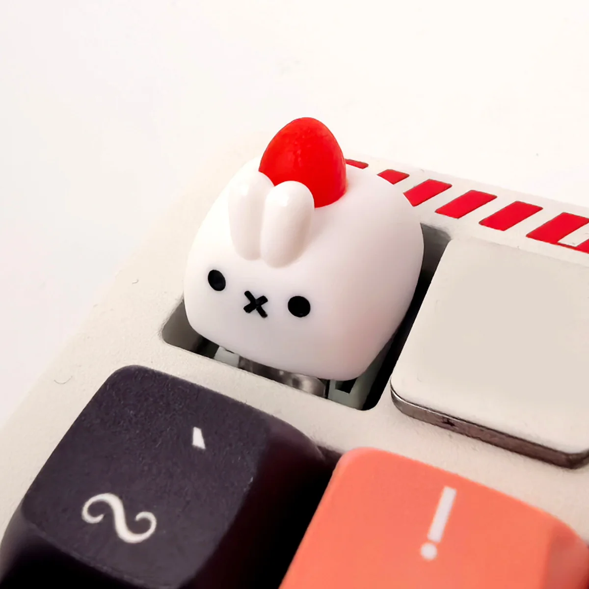 Whimsical artisan rabbit ESC keycap, handcrafted with a charming strawberry design. Multiple angles reveal its tactile texture and intricate details.