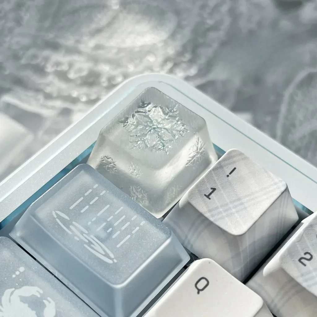 An ethereal translucent artisan snowflake keycap, handcrafted from resin, shown from various angles, glowing softly like winter's first snow.
