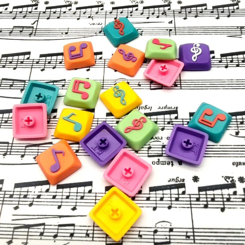 Close-up gallery of Treble Clef Low Shaft Keycaps, showcasing handcrafted resin musical notes with vibrant colors and glossy finish from various angles.
