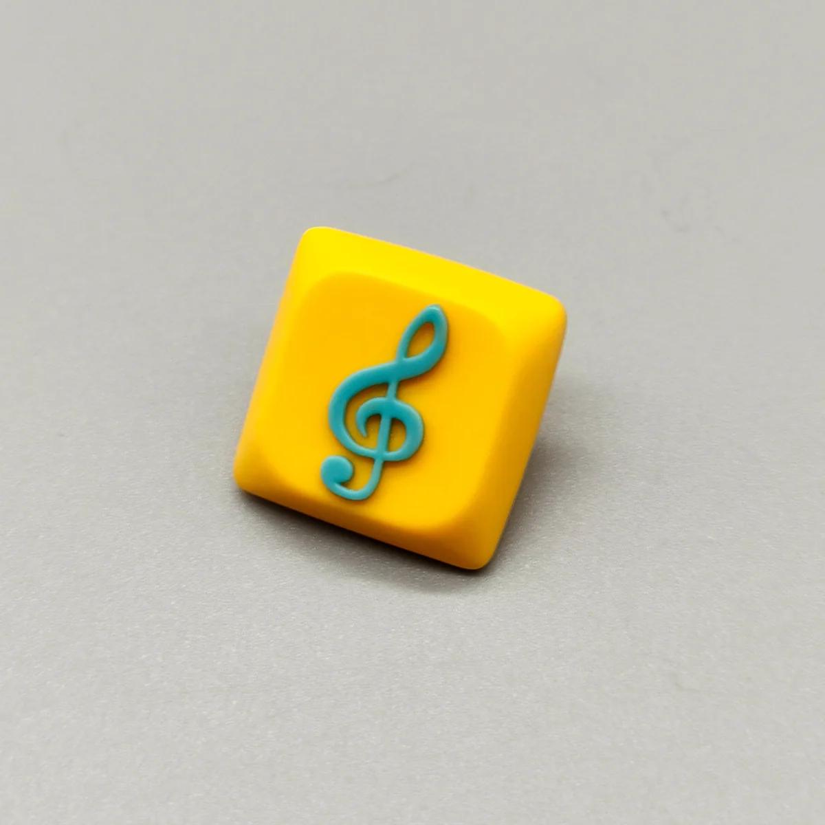 Handcrafted Treble Clef Low Shaft Keycaps featuring a vibrant treble clef design set on a playful yellow base, perfect for music enthusiasts.
