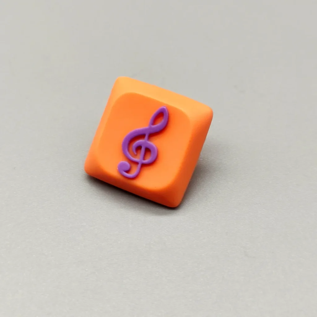 Handcrafted Treble Clef Low Shaft Keycaps featuring a vibrant resin treble clef on a playful orange base. This unique musical note MX keycap enhances any keyboard.
