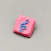 Vibrant pink base Treble Clef Low Shaft Keycaps, handcrafted from resin, showcasing a glossy treble clef symbol.