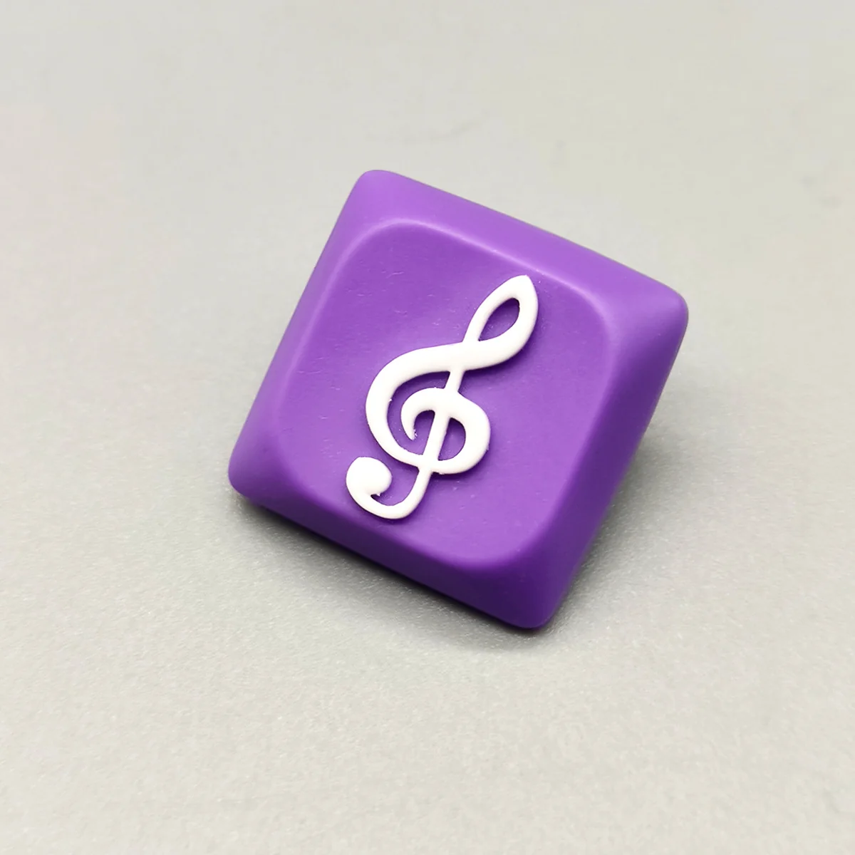 Treble Clef Low Shaft Keycaps featuring a glossy treble clef on a purple resin base.