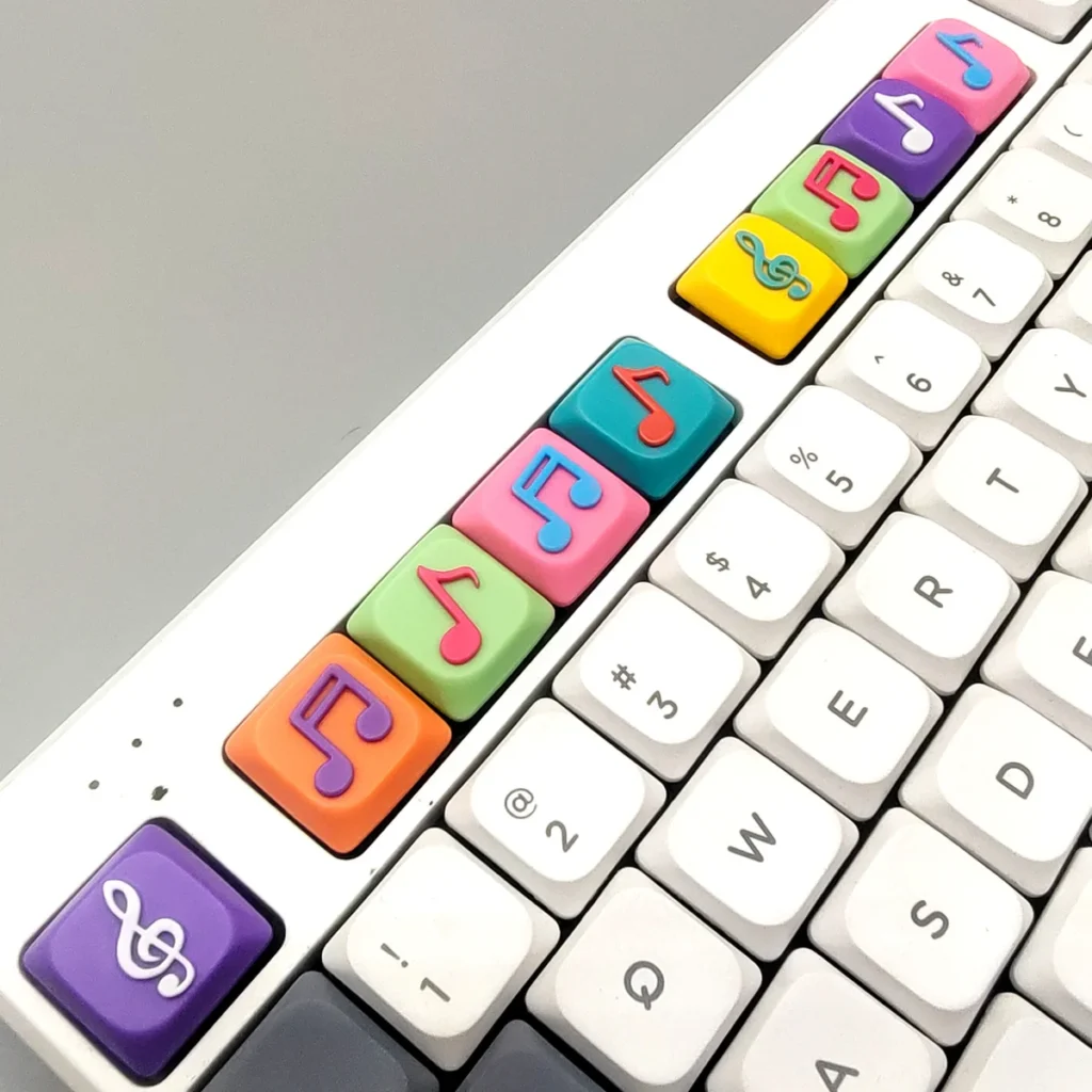 A collection of handcrafted Two Beam Eighth Note Symbol Keycaps, showcasing vibrant translucent resin with embedded musical notes and colorful bases from various argles.
