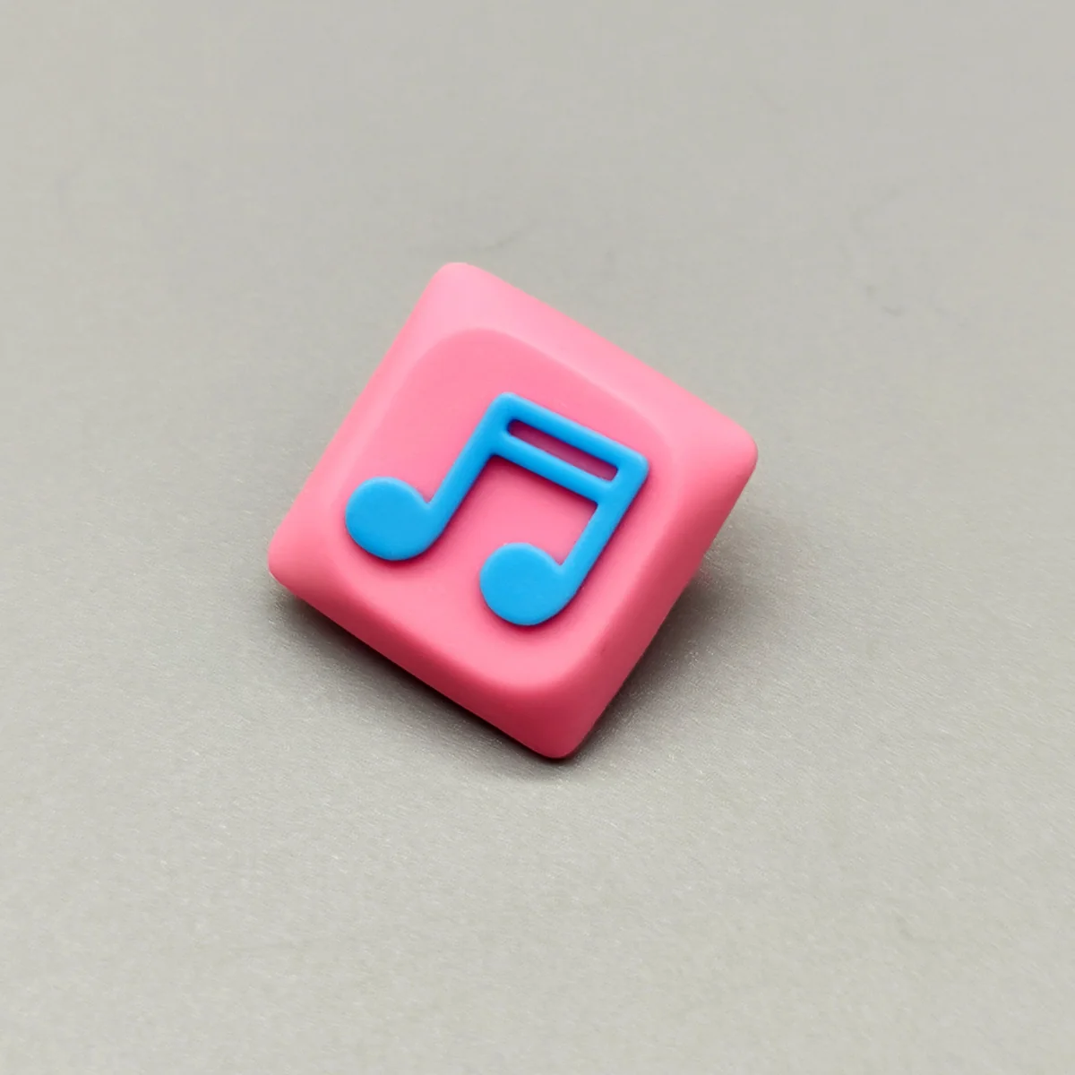 Detailed view of a unique Two Beam Eighth Note Symbol Keycaps, showcasing a vibrant rhythm symbol in translucent resin with a beautiful pink base.