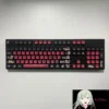 Close-up of the Luminous BanG Dream Ave Mujica PBT Keycap Set, showcasing its dark, stylized design and vibrant, all-around backlit legends.