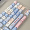 Playful White Rabbit MOA PBT keycaps set, featuring iconic milky white, blue, and red spherical profiles. Durable PBT, comfy MOA for nostalgic keyboard.
