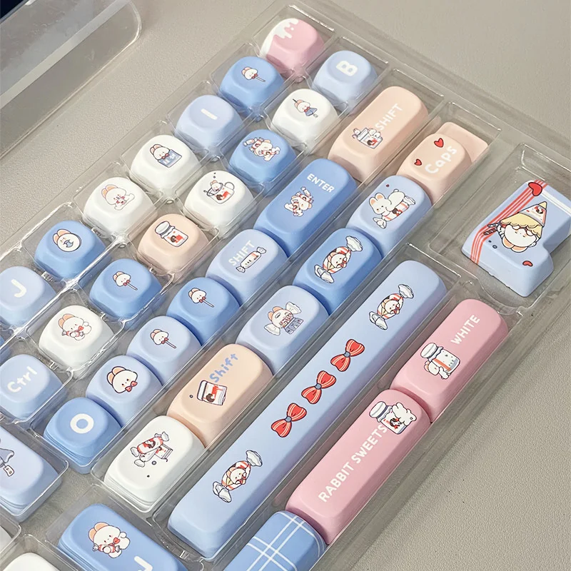 Playful White Rabbit MOA PBT keycaps set, featuring iconic milky white, blue, and red spherical profiles. Durable PBT, comfy MOA for nostalgic keyboard.