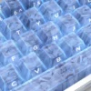 Exclusive blue forged carbon keycap set gallery, showcasing the dynamic texture and modern side-printed legends from various premium angles.