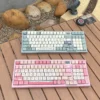 Artistic botanical keycaps set, featuring vibrant green illustrations and delicate floral accents on durable MDA PBT, presented from various angles to view.
