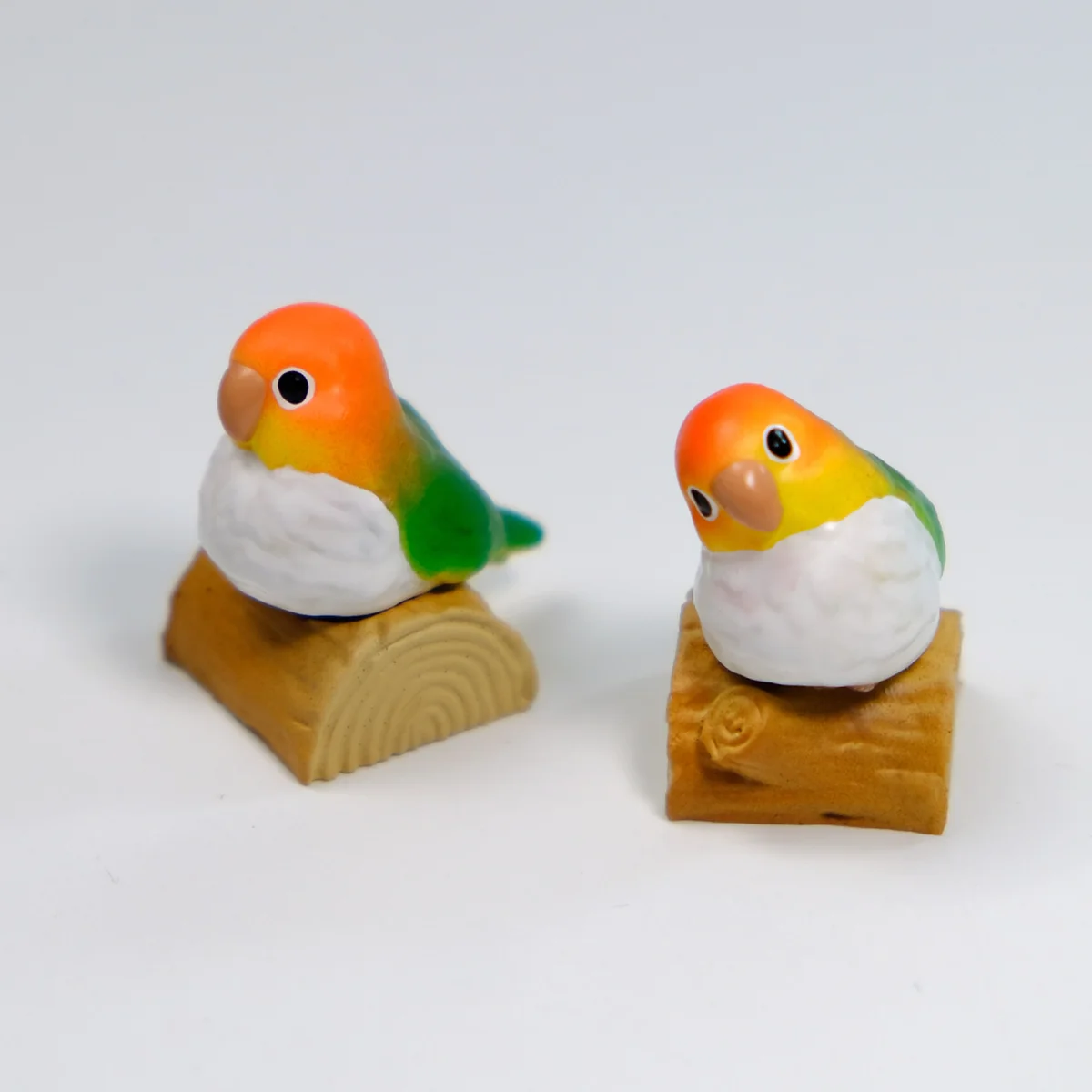 A gallery of exquisitely handcrafted Caique parrot artisan keycaps, showcasing vibrant, lifelike details from multiple angles, perfect for a whimsical design.