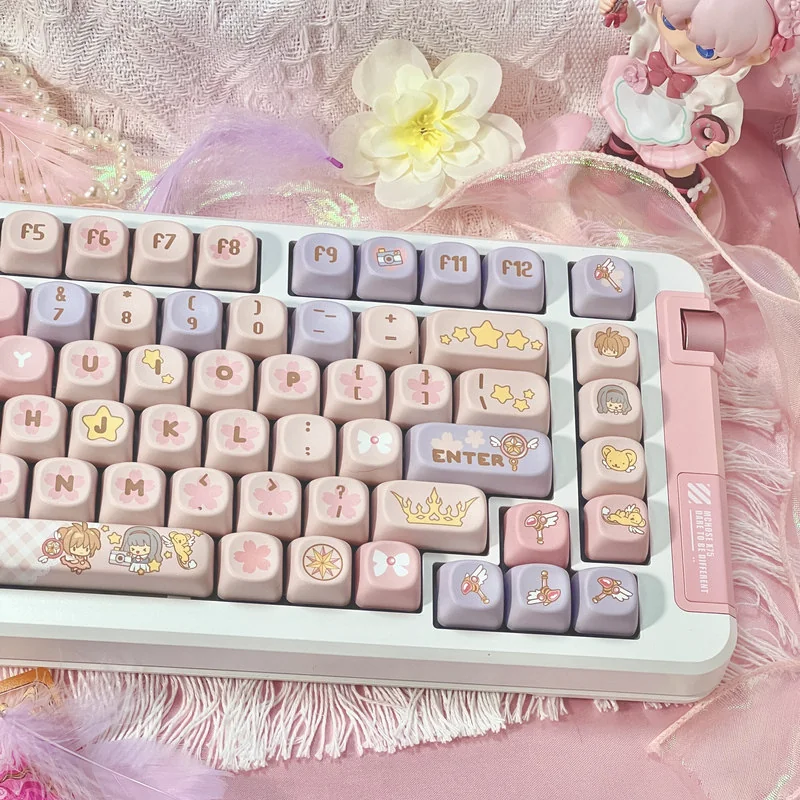Iconic Cardcaptor Sakura PBT dye-sub keycap set, featuring whimsical pastel pink and purple anime motifs from various enchanting angles.