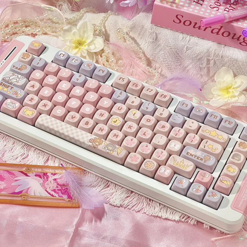 Iconic Cardcaptor Sakura PBT dye-sub keycaps set in a playful arrangement, showcasing whimsical pastel pink and purple magical anime motifs from a fresh aesthetics.