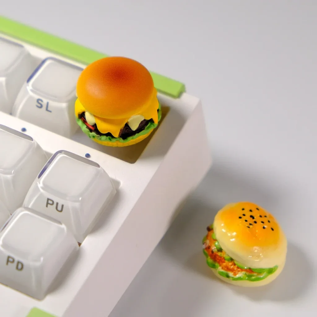 Our vibrant, realistic Cheese Burger Keycap is more than just an accessory, which showcasing multiple angles of the burger angles.