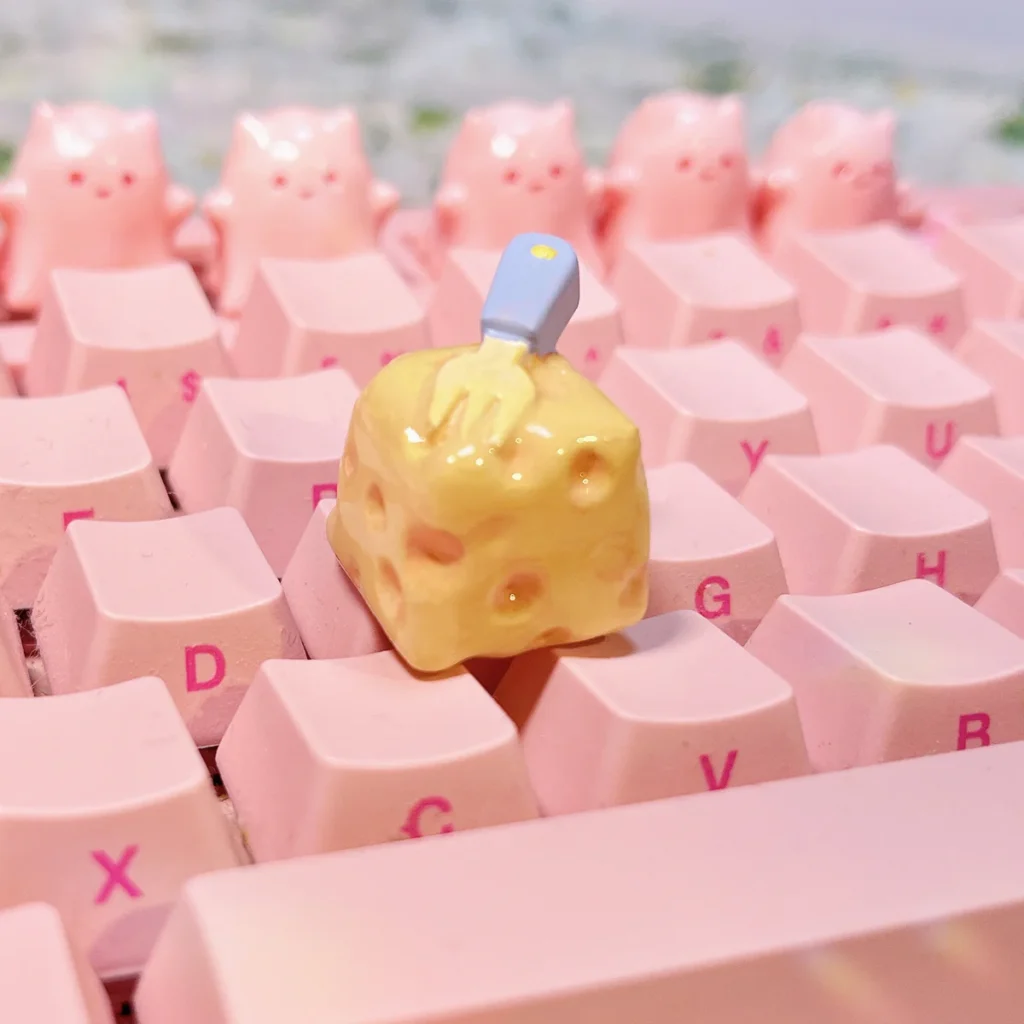 Handcrafted whimsical cheesecake artisan keycap gallery, showing its adorable miniature realism and playful fork detail from multiple charming angles.