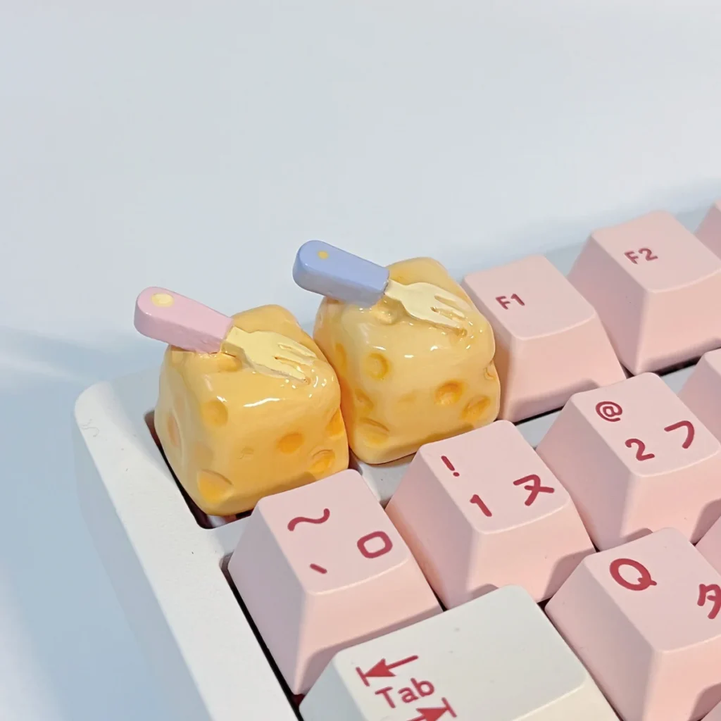 Whimsical handcrafted cheesecake keycap, a miniature realistic dessert with a playful fork. Adorable premium artisan accessory.
