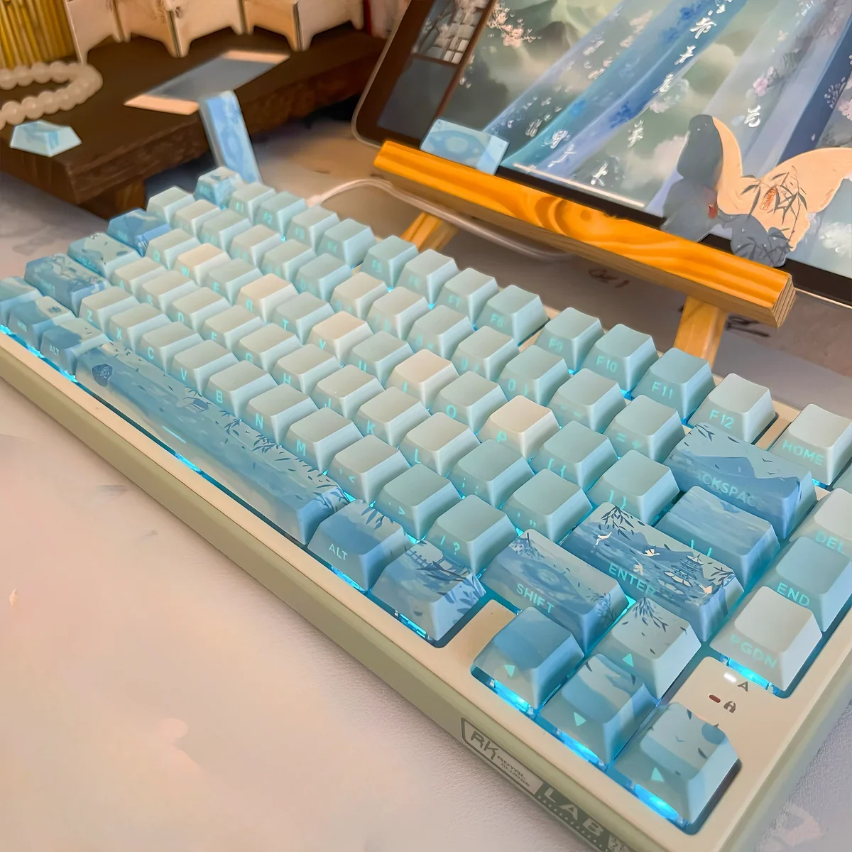 Detailed view of tranquil PBT Tranquil Chinese Landscape Cherry Keycap Set, showcasing illuminated misty mountain artwork and flowing river designs.