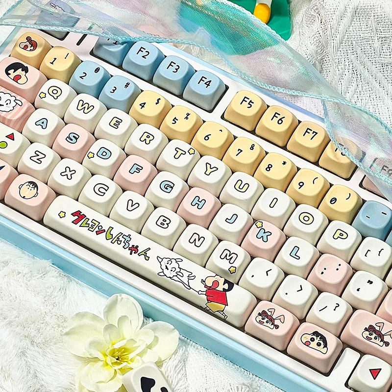 Vibrant Crayon Shin-chan PBT MOA keycap set, featuring mischievous Shin-chan art on smooth, spherical keycaps, displayed from multiple playful angles.
