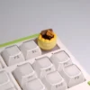 Whimsical dessert artisan keycaps shown from various angles, highlighting their intricate handcrafted details and vibrant 3D miniature design.