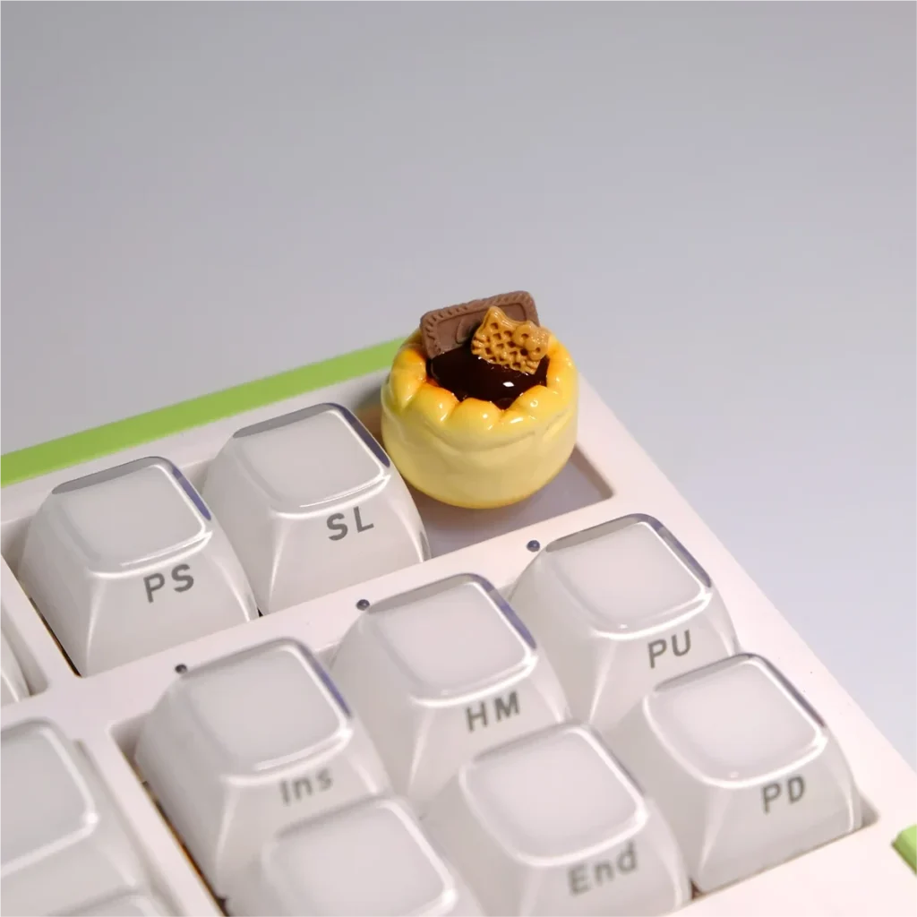 Whimsical dessert artisan keycaps shown from various angles, highlighting their intricate handcrafted details and vibrant 3D miniature design.
