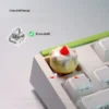 Whimsical handcrafted keycap, featuring a sweet 3D dessert enjoying a vibrant strawberry chiffon dessert, intricately detailed.